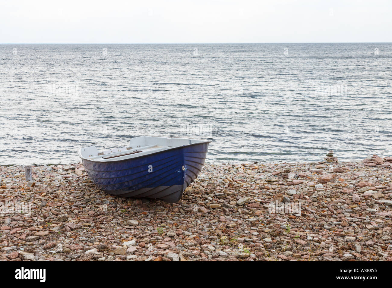 Bateau à rames à une plage de galets de la mer Banque D'Images
