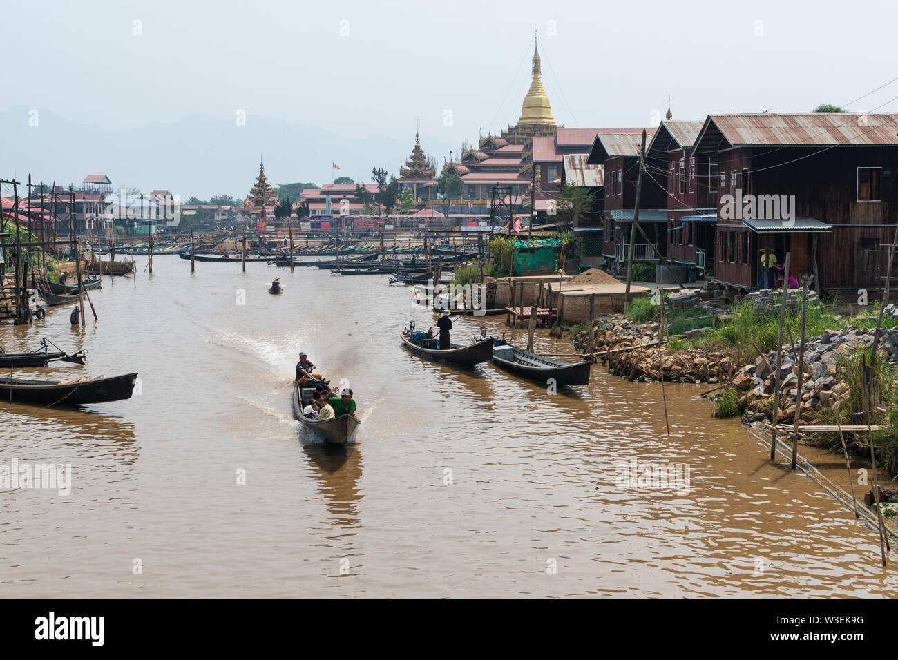 Haspres Thauk, Myanmar - Avril 2019 : Birman traditionnel maison flottante reflétant dans l'eau du lac Inle. Banque D'Images