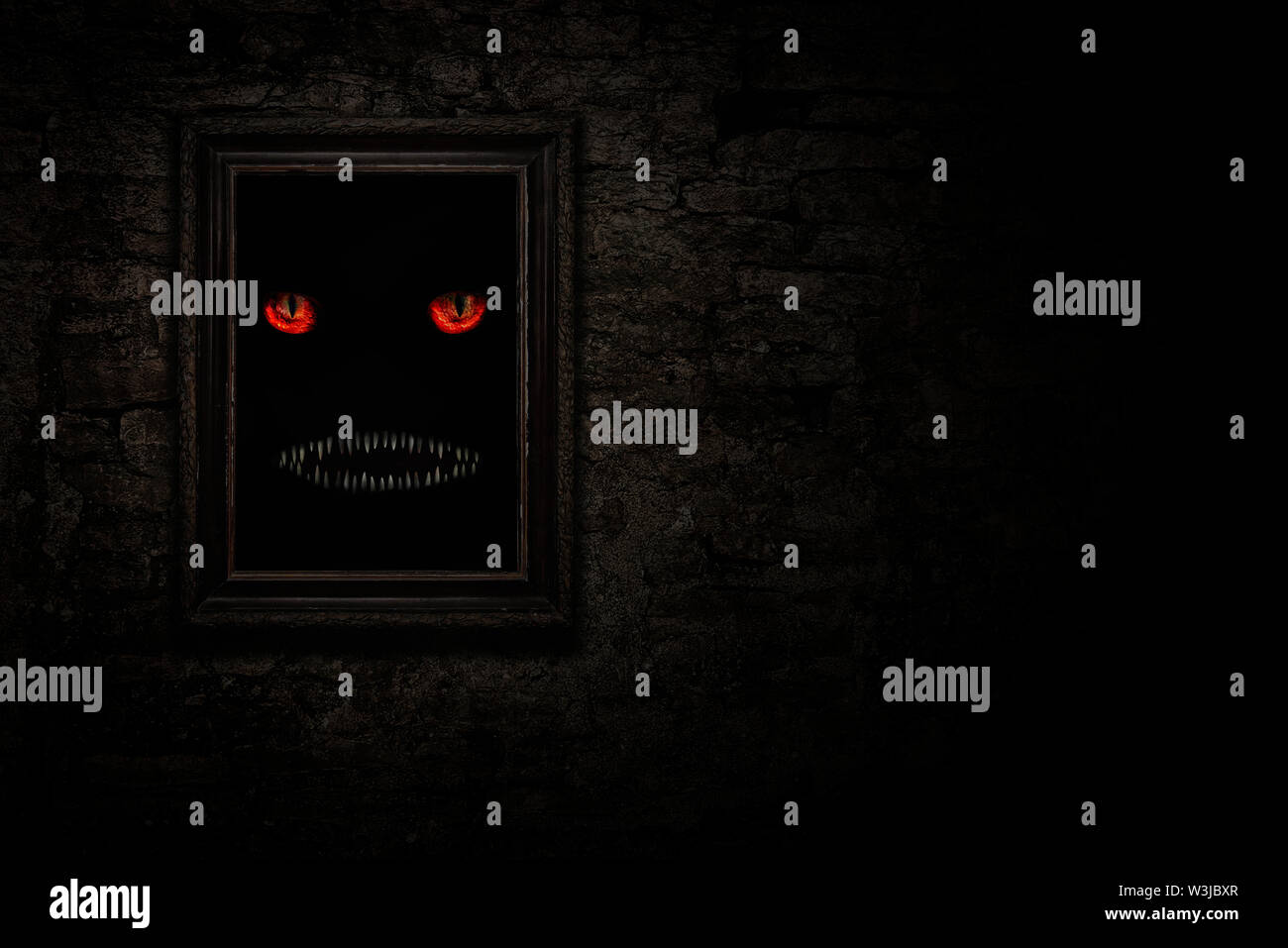 Vintage frame sur le vieux mur de brique avec Monster, yeux et dents Banque D'Images