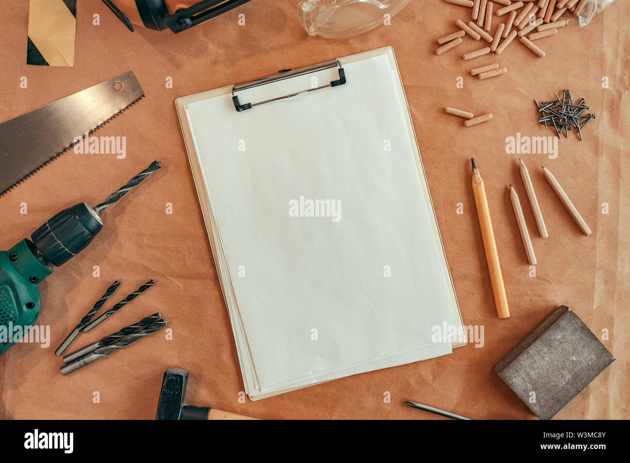 Notez papier sur le presse-papiers maquette bois menuiserie 24 avec différents outils du commerce, vue du dessus Banque D'Images