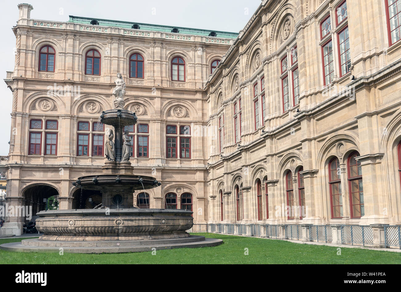 Fontaine près de l'Opéra d'État de Vienne sur pelouse verte à Vienne, Autriche Banque D'Images