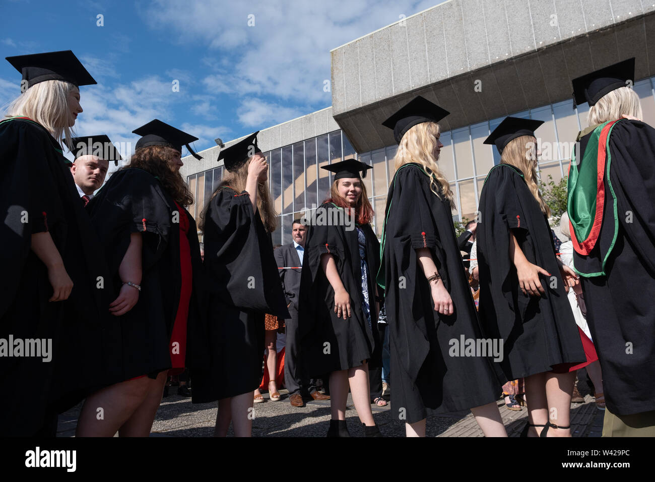 L'enseignement supérieur au Royaume-Uni - les élèves qui réussissent à la remise des diplômes à l'université d'Aberystwyth, après avoir reçu leur diplôme, portant leurs chapeaux traditionnels et des blouses. Juillet 2019 Banque D'Images