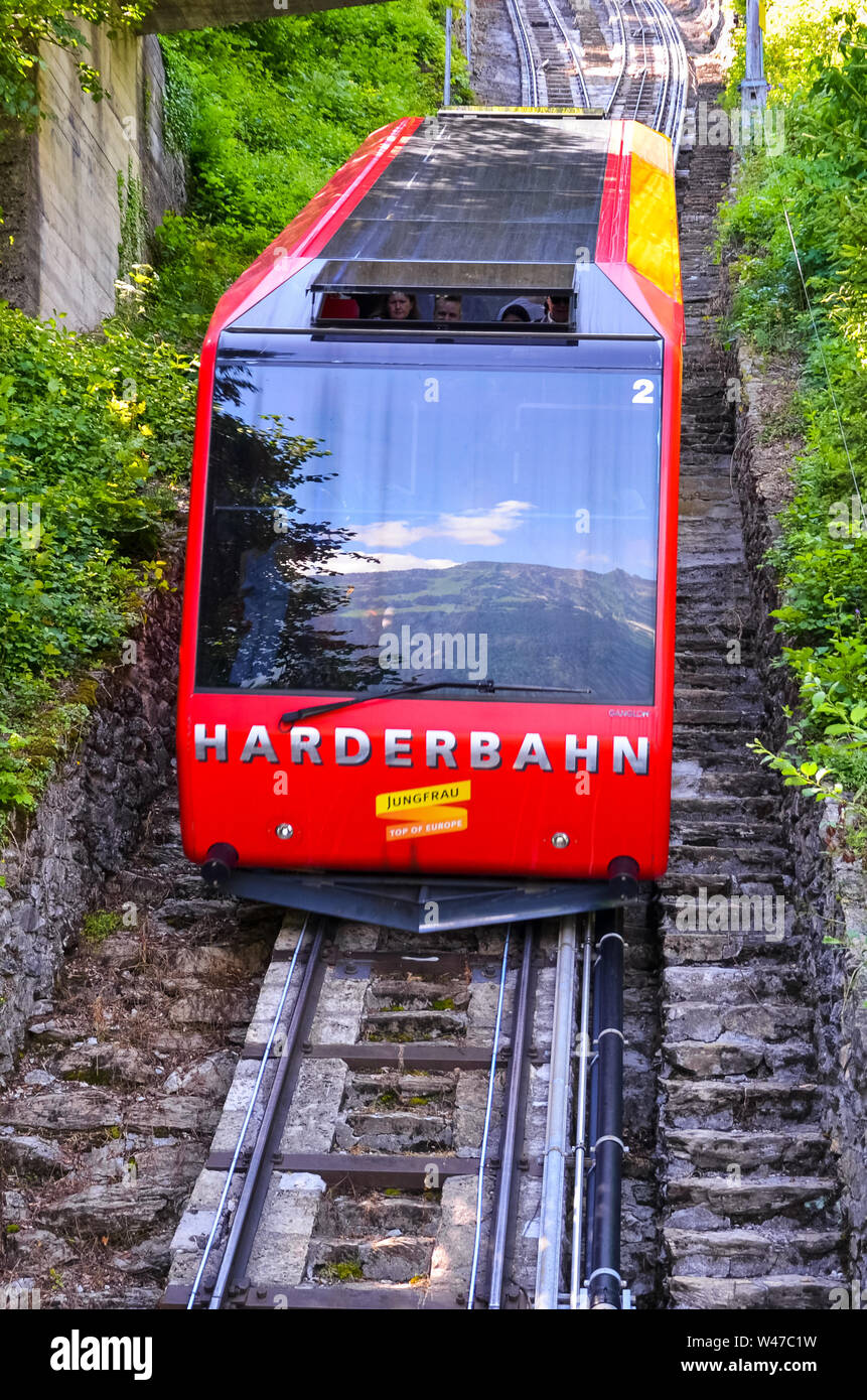 Interlaken, Suisse - le 16 juillet 2019 : téléphérique rouge en descente de Kulm, plus haut de Interlaken. Les lecteurs de funiculaire de touristes en haut et en bas du point de vue populaire. Le transport, le tourisme. Banque D'Images