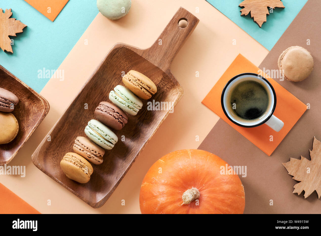 Macarons et espresso, télévision le poser sur papier fond géométrique dans des tons pastel avec des décorations d'automne Banque D'Images