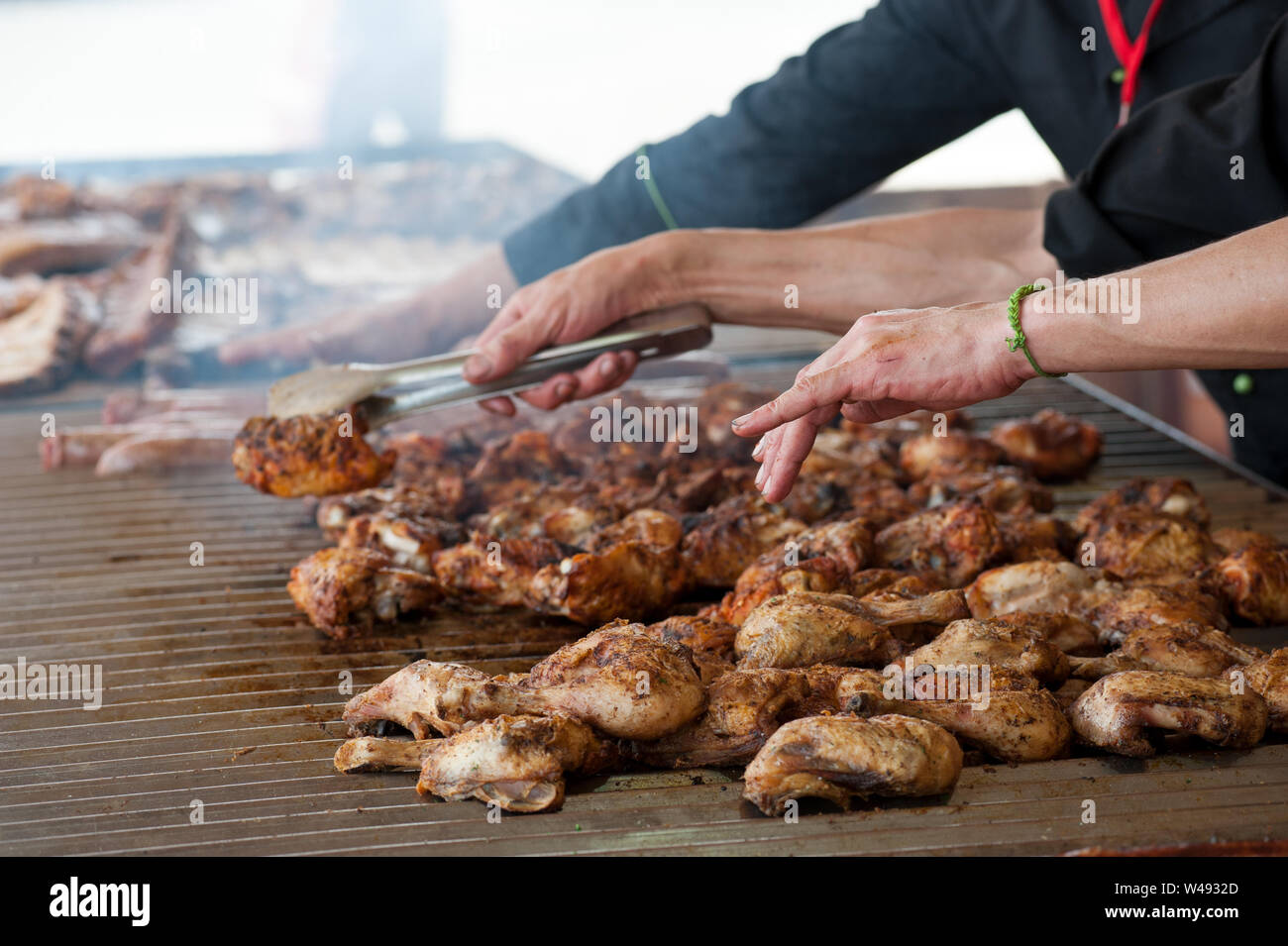 Man grilling un assortiment de viande et grillé sur un grand barbecue Banque D'Images