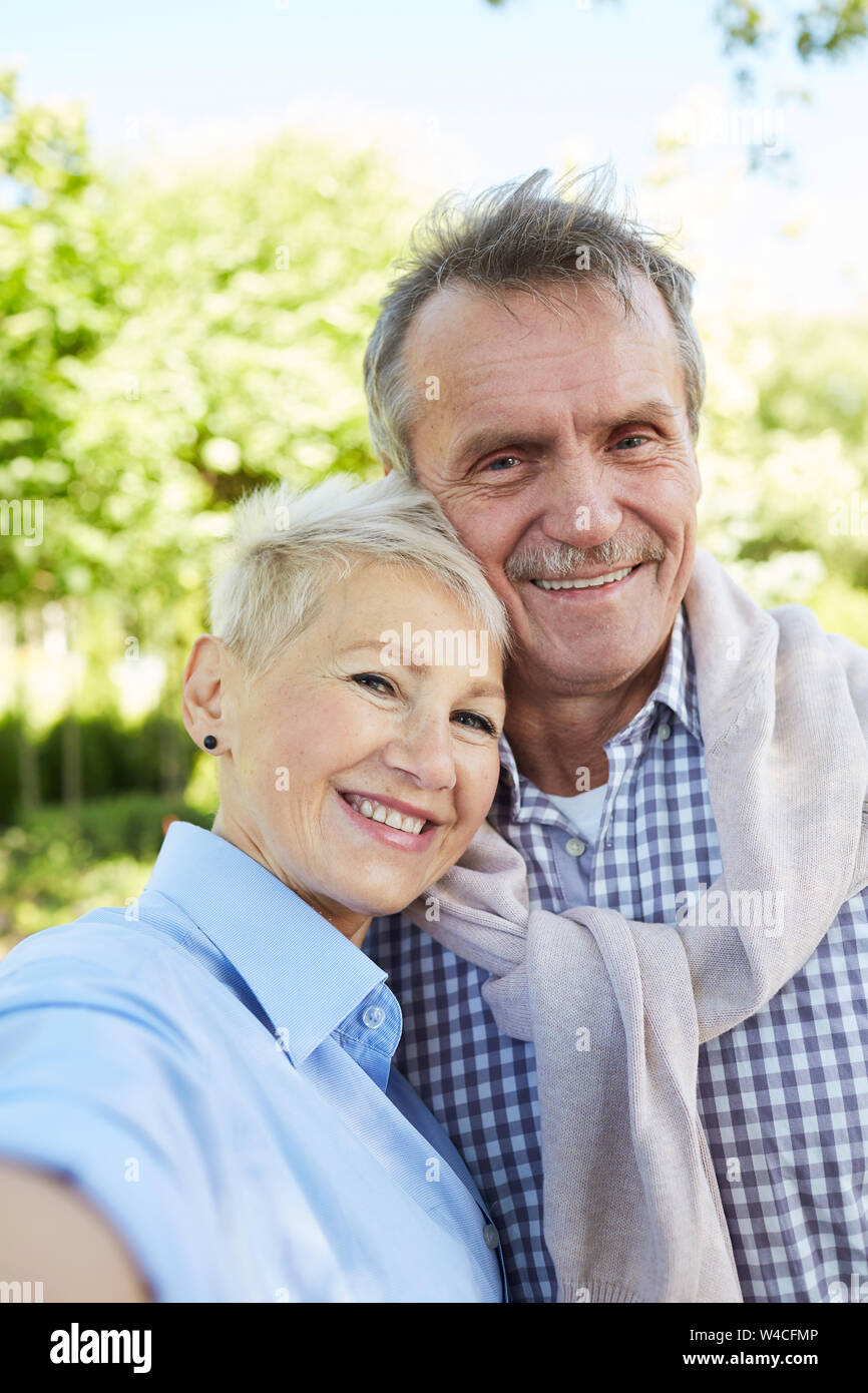 Portrait de senior couple smiling at camera extérieur tout en posant pour la photo selfies Banque D'Images
