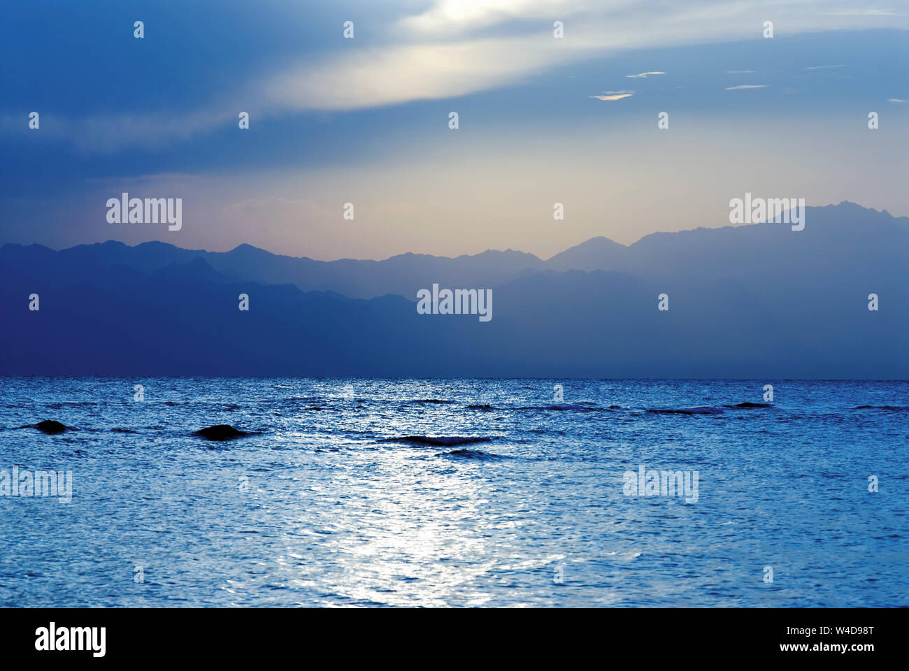 Coucher du soleil en mer contre misty côte, golfe d'Aqaba, l'Égypte Banque D'Images
