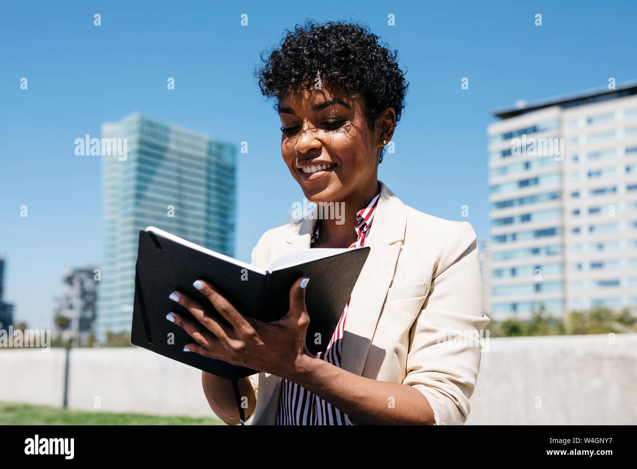 Femme à écrire des notes sur un ordinateur portable Banque D'Images