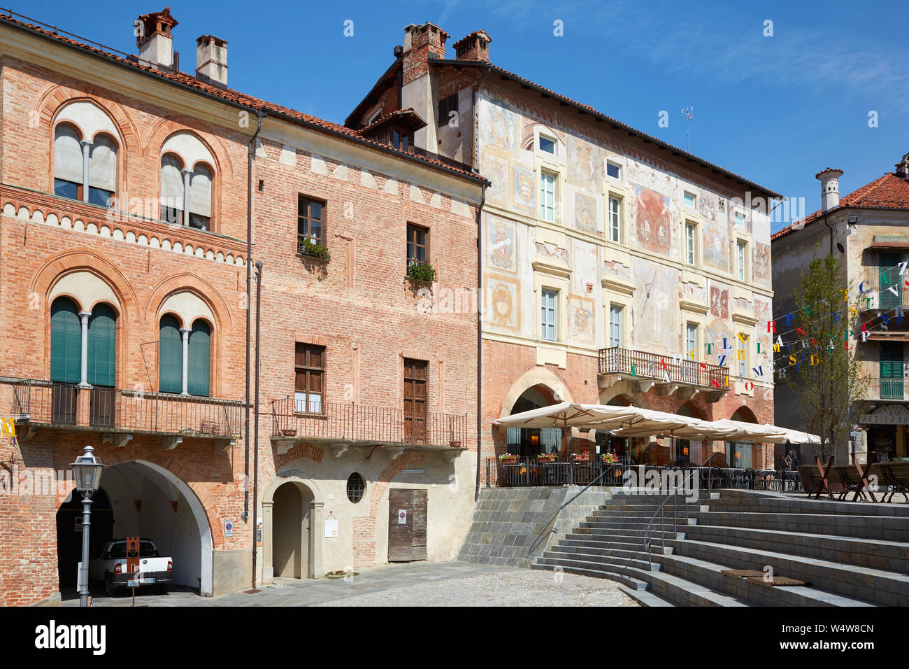 MONDOVI, ITALIE - 18 août 2016 : anciens bâtiments de briques rouges et de fresques dans une journée ensoleillée, la place de la ville de Mondovi, en Italie. Banque D'Images