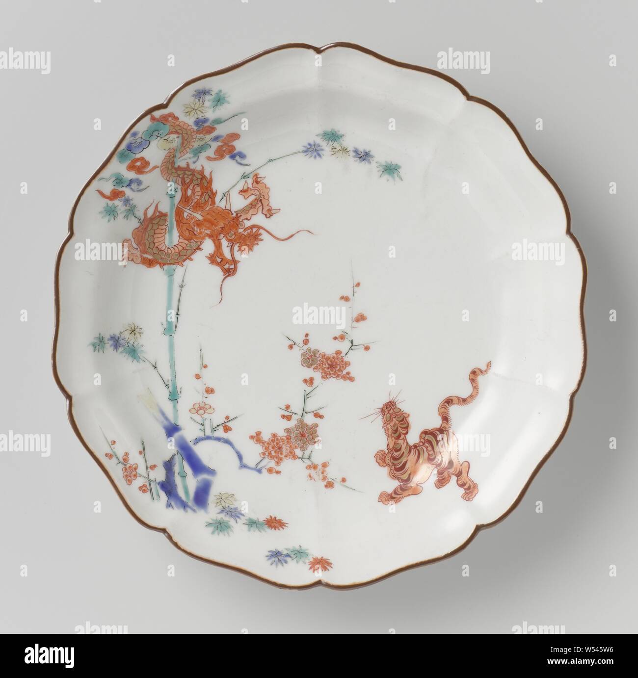 Plat de homard avec Dragon, Tigre, bambou et prunus, assiette de porcelaine avec un bord lobé, peinte sur l'émail en bleu rouge, vert, jaune, noir et or avec un tigre près de prunus, jusqu'à la à un enroulement dragon autour d'un bambou. Border Brown. Quatre proen sur le fond. Theodore Kakiemon, Jean Royer, anonyme, le Japon, l'c. 1670 - c. 1690, période Edo (1600-1868), Porcelaine, glaçure (matériel), de l'or (métal), la vitrification, H 3,4 cm d 18,1 cm d 10,9 cm Banque D'Images