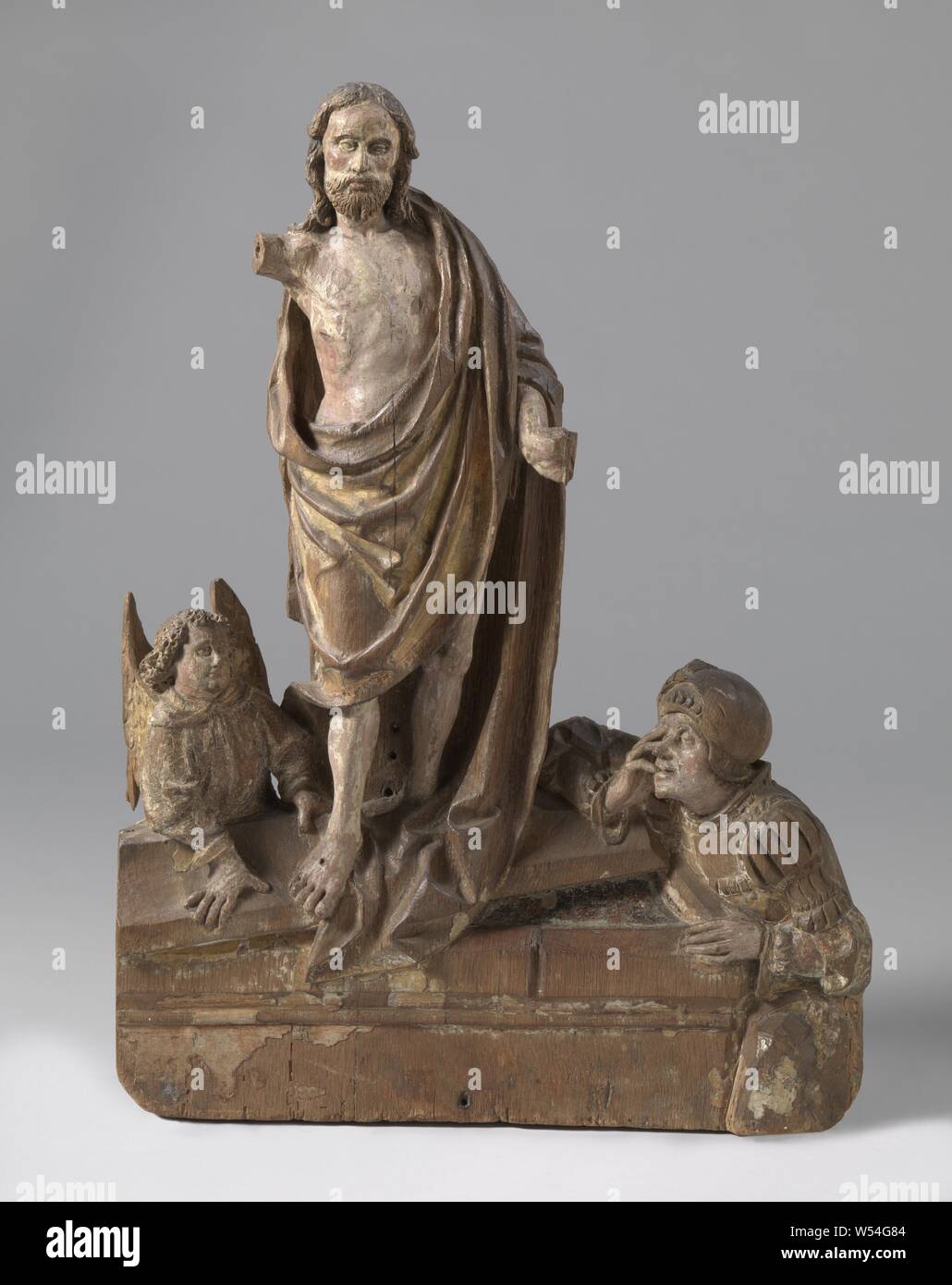 La Résurrection, sur un couvercle incliné de la tombe, Christ se tient avec le pied droit en avant. Les autres le bras droit est soulevé à la différence de la pendaison avec la main gauche tournée vers l'extérieur. Vers la droite contre le côté court de la tombe, un soldat agenouillé se penche avec le bras droit sur le couvercle de la tombe, les yeux de qui sont à mi-lazied et la bouche brièvement ouvert. La main gauche comprend un coin de la tombe. Sur le côté gauche, derrière le tombeau un ange se penche avec les deux mains sur le couvercle. Le manteau du Christ s'étend de l'épaule gauche dans un large arc à gauche sous le faux Banque D'Images