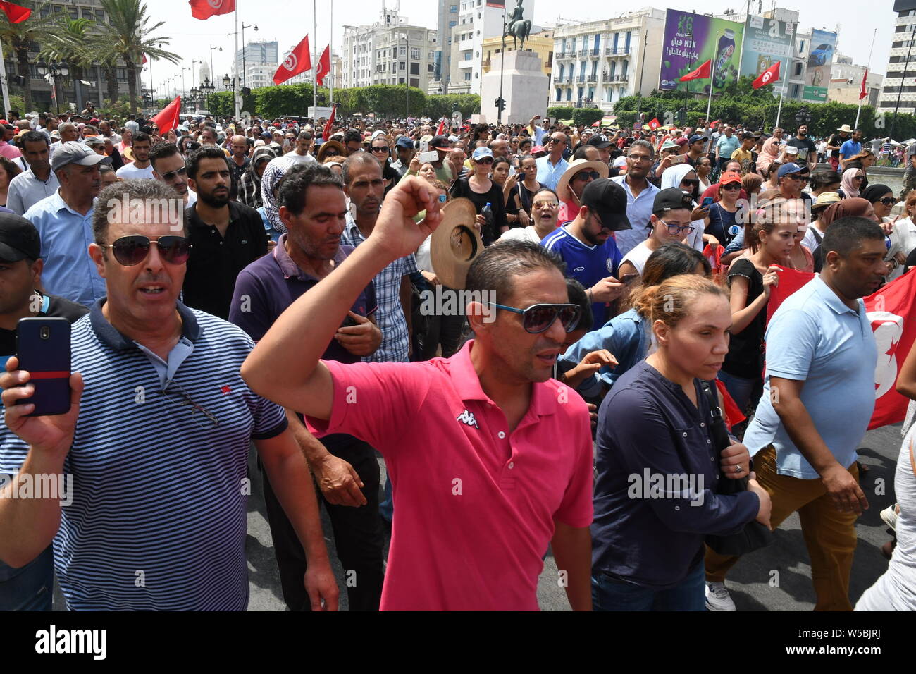 Tunis, Tunisie. 27 juillet, 2019. Les gens regardent le défilé militaire qui accompagne le cercueil de la fin Le président tunisien BEJI CAID ESSEBSI au cours de ses funérailles d'État à Tunis, Tunisie, le 27 juillet 2019. Peuple tunisien payé le samedi leur dernier hommage au défunt Président BEJI CAID ESSEBSI, décédé jeudi matin à l'âge de 92 ans. Source : Xinhua/Alamy Live News Banque D'Images