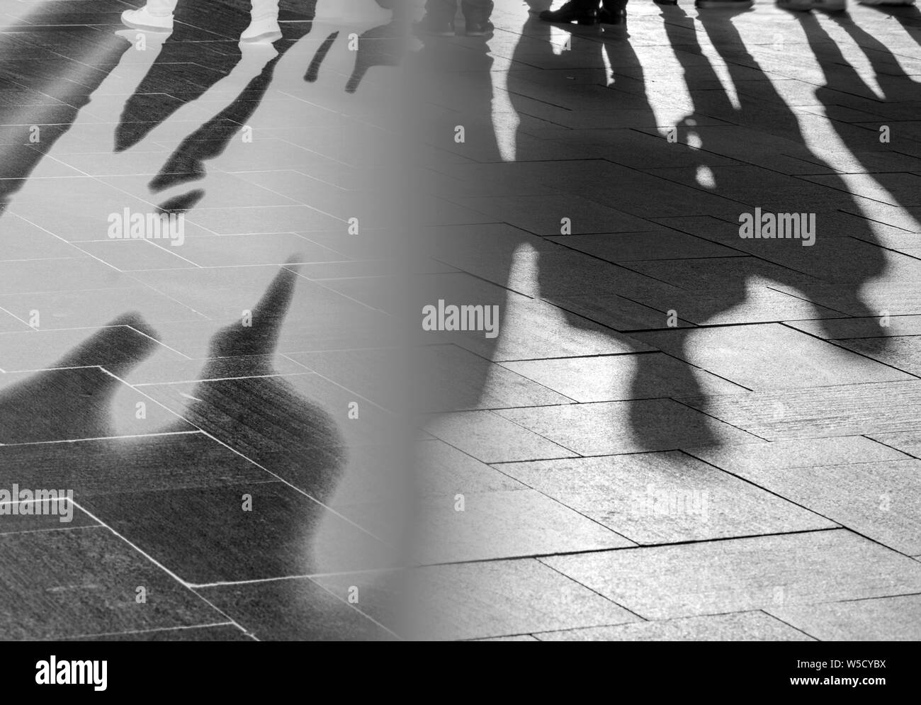 Ombres et silhouettes de personnes sur un trottoir comme arrière-plan Banque D'Images