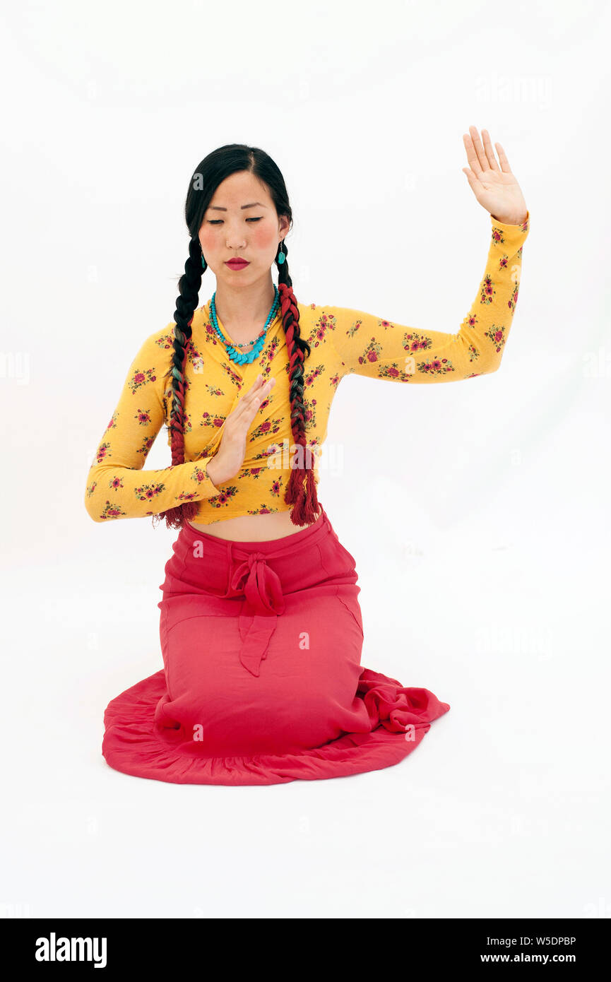 Belle asiatique spirituel américain coréen femme agenouillée devant l'expression d'expression rituelle. Banque D'Images