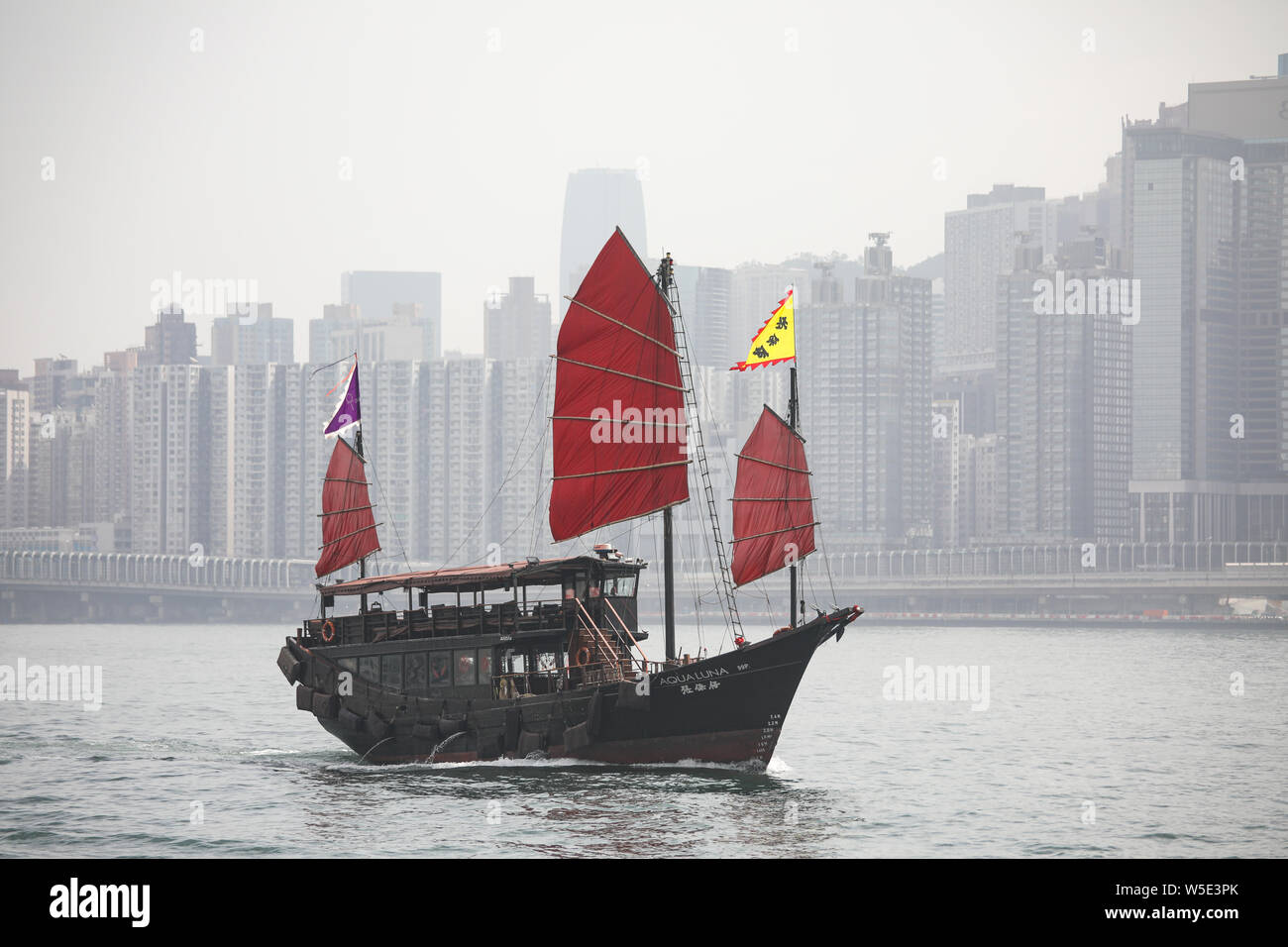 Junk ship Aqua Luna sur Victoria Harbour, l'île de Hong Kong sur l'arrière-plan Banque D'Images