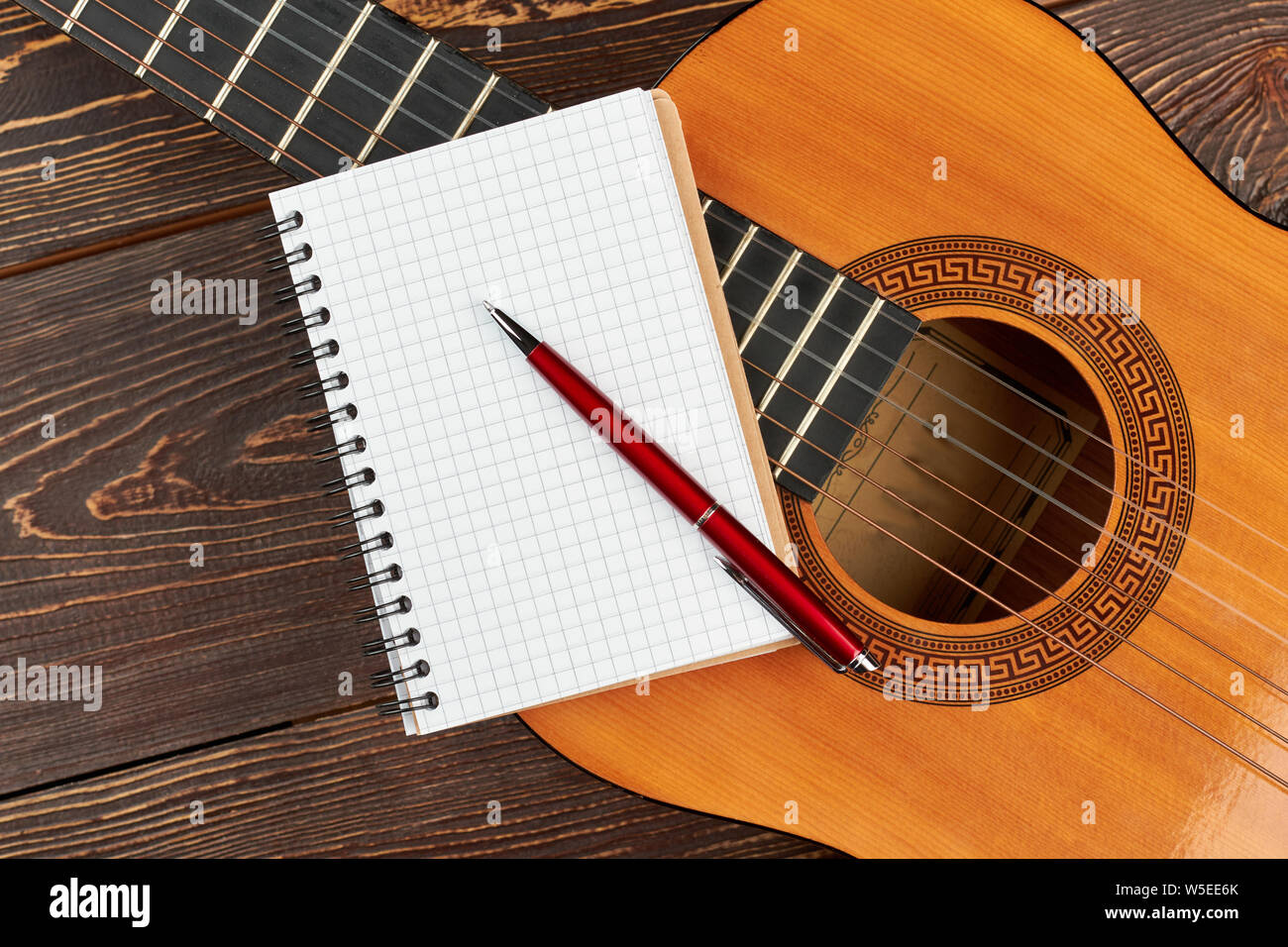 Bloc-notes vierge et stylo sur guitare. Banque D'Images