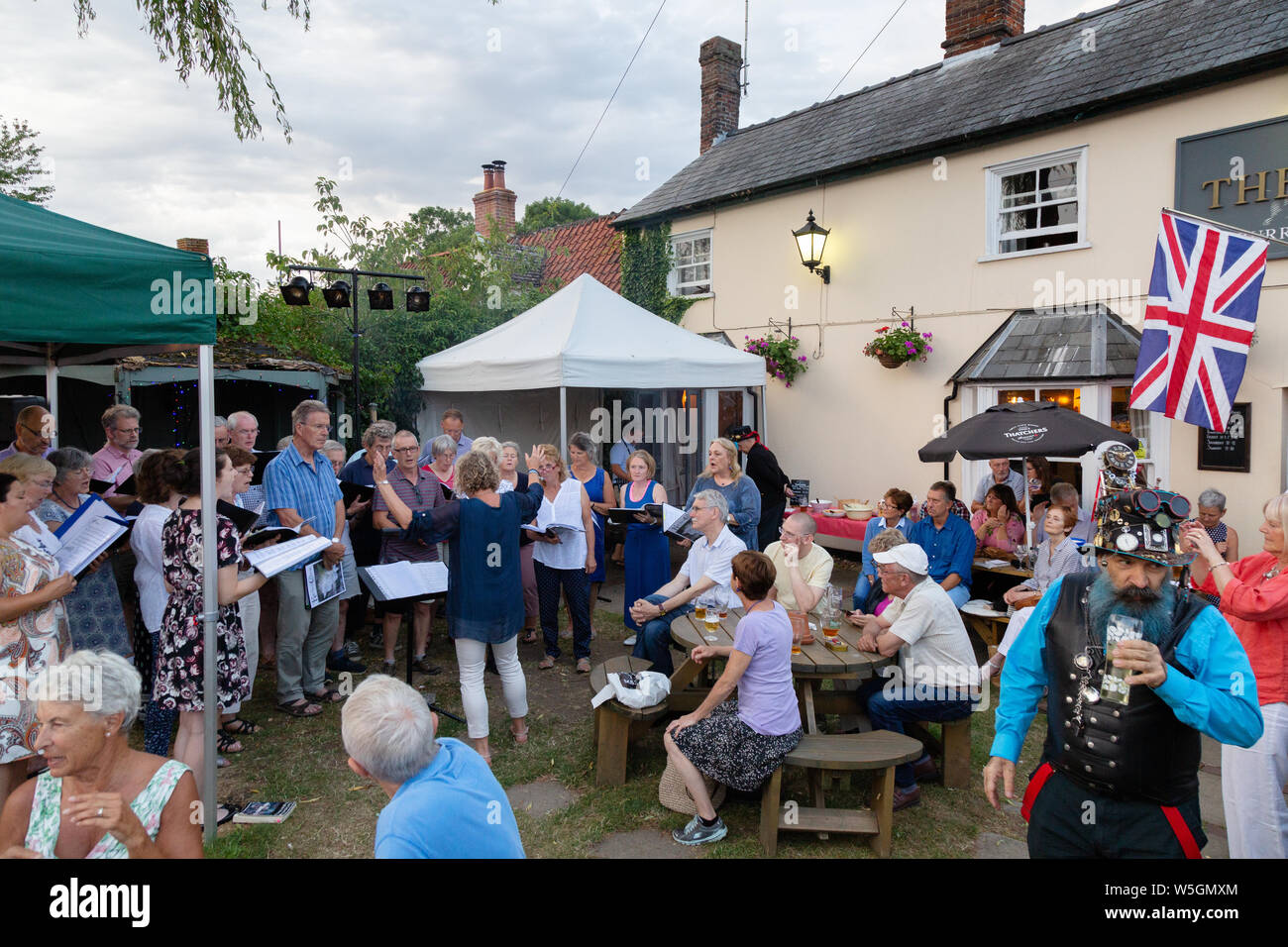 Pub Anglais ; un chœur chantant à l'extérieur dans un pub à chanter en été, le Bull Pub, Burrough Green Village, Cambridgeshire UK Banque D'Images Pub Anglais ; un chœur chantant à l'extérieur dans un pub à chanter en été, le Bull Pub, Burrough Green Village, Cambridgeshire UK Banque D'Images