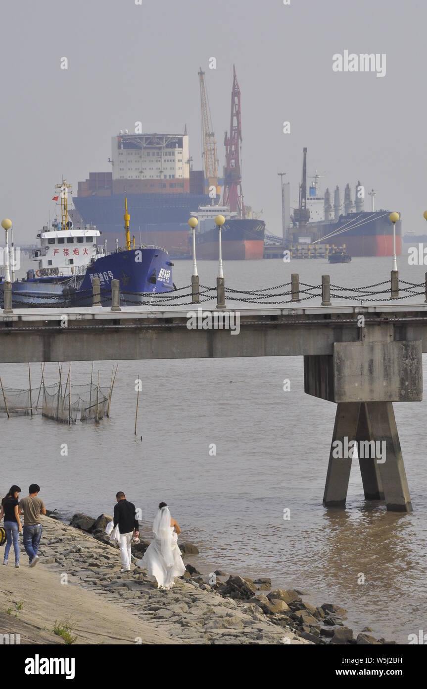 Un couple de jeunes mariés ayant leurs photos de mariage prises sur les rives du Yangtsé Nantong Chine Banque D'Images