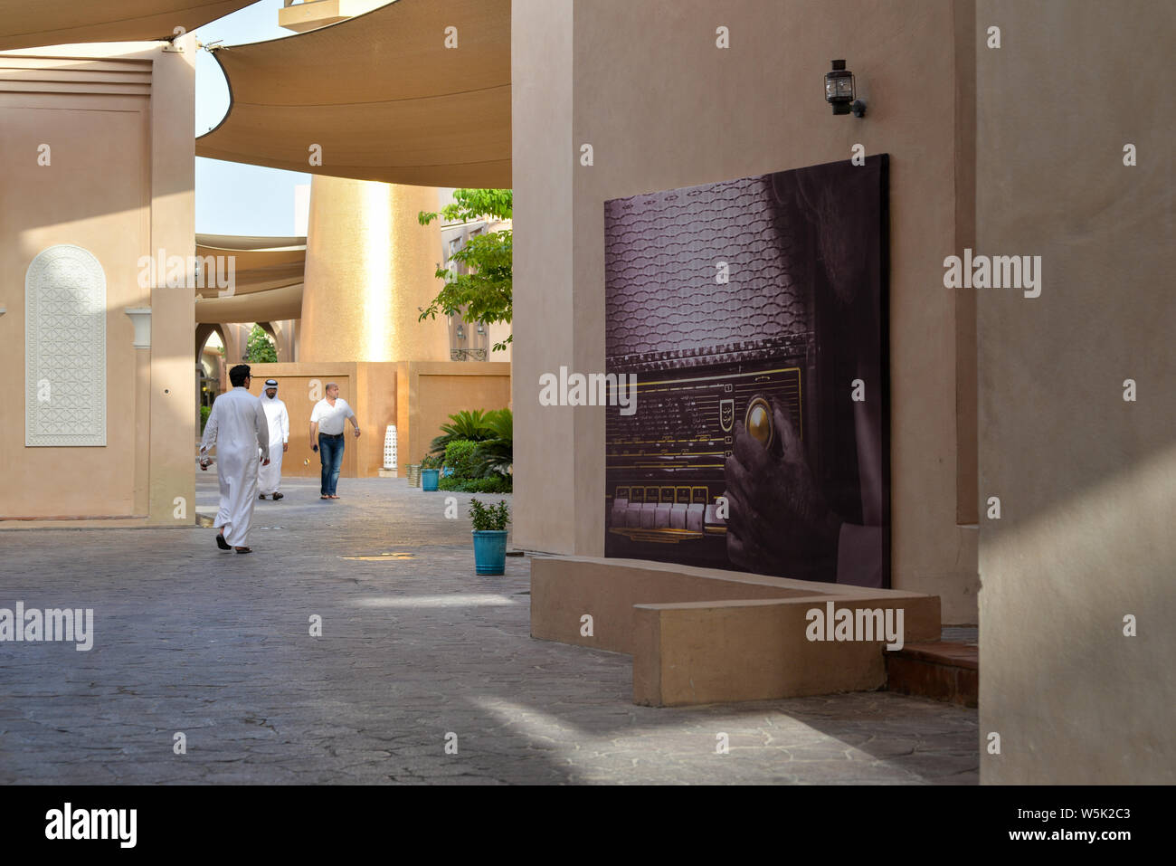 DOHA, QATAR - 27 MAI 2016 : les passants et affiche d'un vintage radio à la Katara Cultural Village. Photo prise à la fin d'un après-midi de printemps. Banque D'Images
