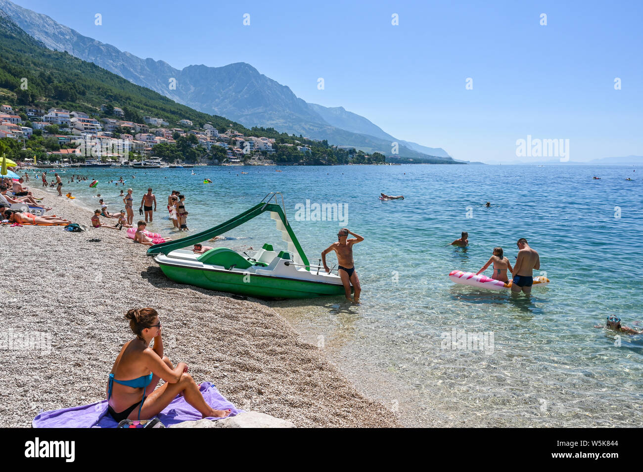 Les touristes profiter de la plage de Brela. La riviera de Makarska en Croatie est célèbre pour ses belles plages de galets et de l'eau claire comme du cristal. Banque D'Images