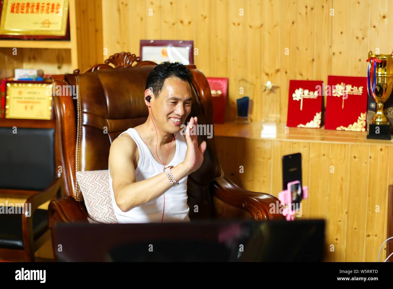 Handicapés chinois man su rend Hongxing live streaming webcast pour vendre les porcs miniatures sur Alibaba's plate-forme e-commerce Taobao à un village de forestiers Banque D'Images