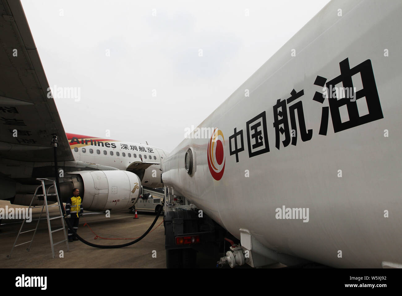 --FILE--Un travailleur chinois est à côté d'un réservoir de carburant d'Aviation Group China National (CNAF) à l'aéroport de Nantong Nantong Xingdong en ville, à l'Est Banque D'Images