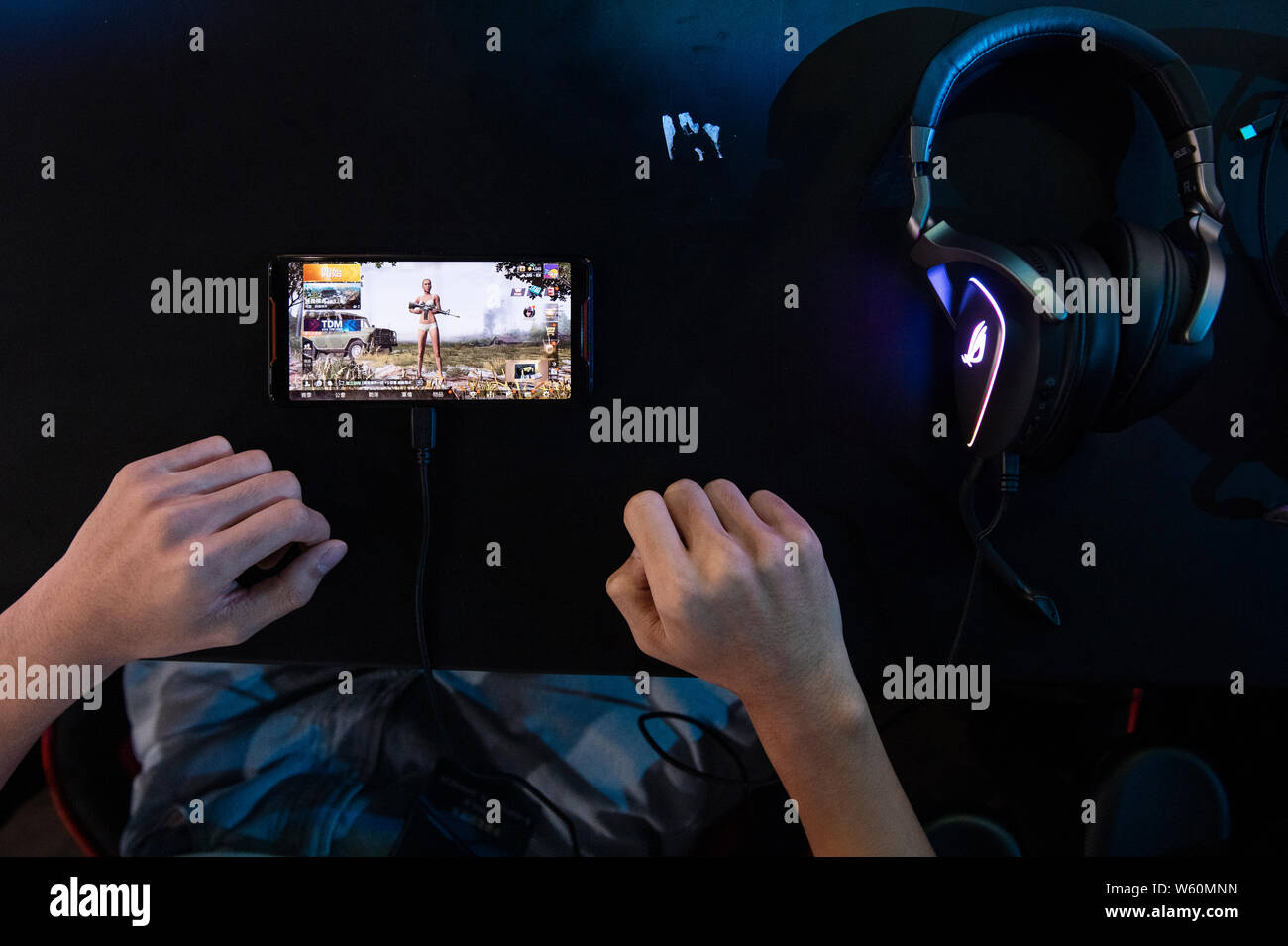 Un concurrent joue le jeu mobile au cours de l'E-sport et de la musique de Hong Kong. Banque D'Images