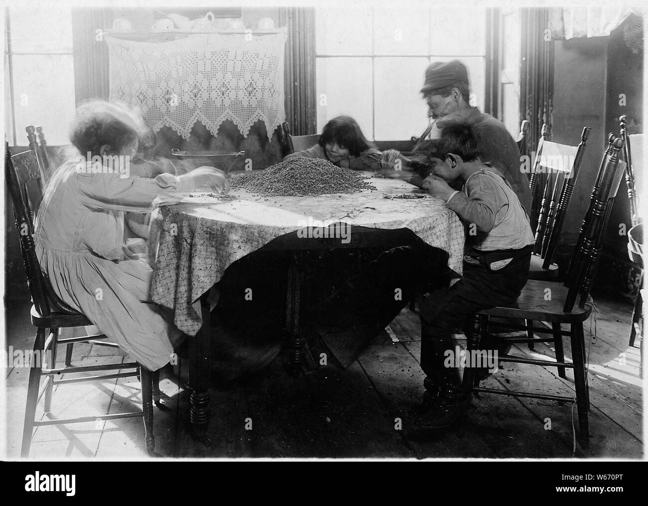 De gauche à droite : Florence Lieto, 10 ans. Jennie Macola, 10 ans. Mamie Macola, 8 ans. Nicholas Macola, 6 ans. Les solutions d'orfèvre. Les balayures coût 25 [C.] un sac à l'entrepôt, et choisi au-dessus de café se vend à environ 12 [C.] la livre. L'homme travaillant avec le mal de main liée jusqu'au bandage. Après les heures de travail des enfants et le samedi. La ville de New York. Banque D'Images