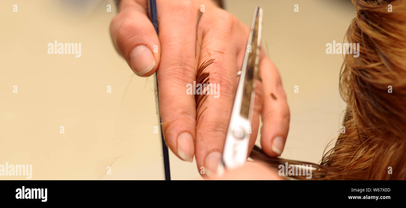 Coiffure avec des ciseaux et peigne en main c'est la coupe de cheveux Banque D'Images