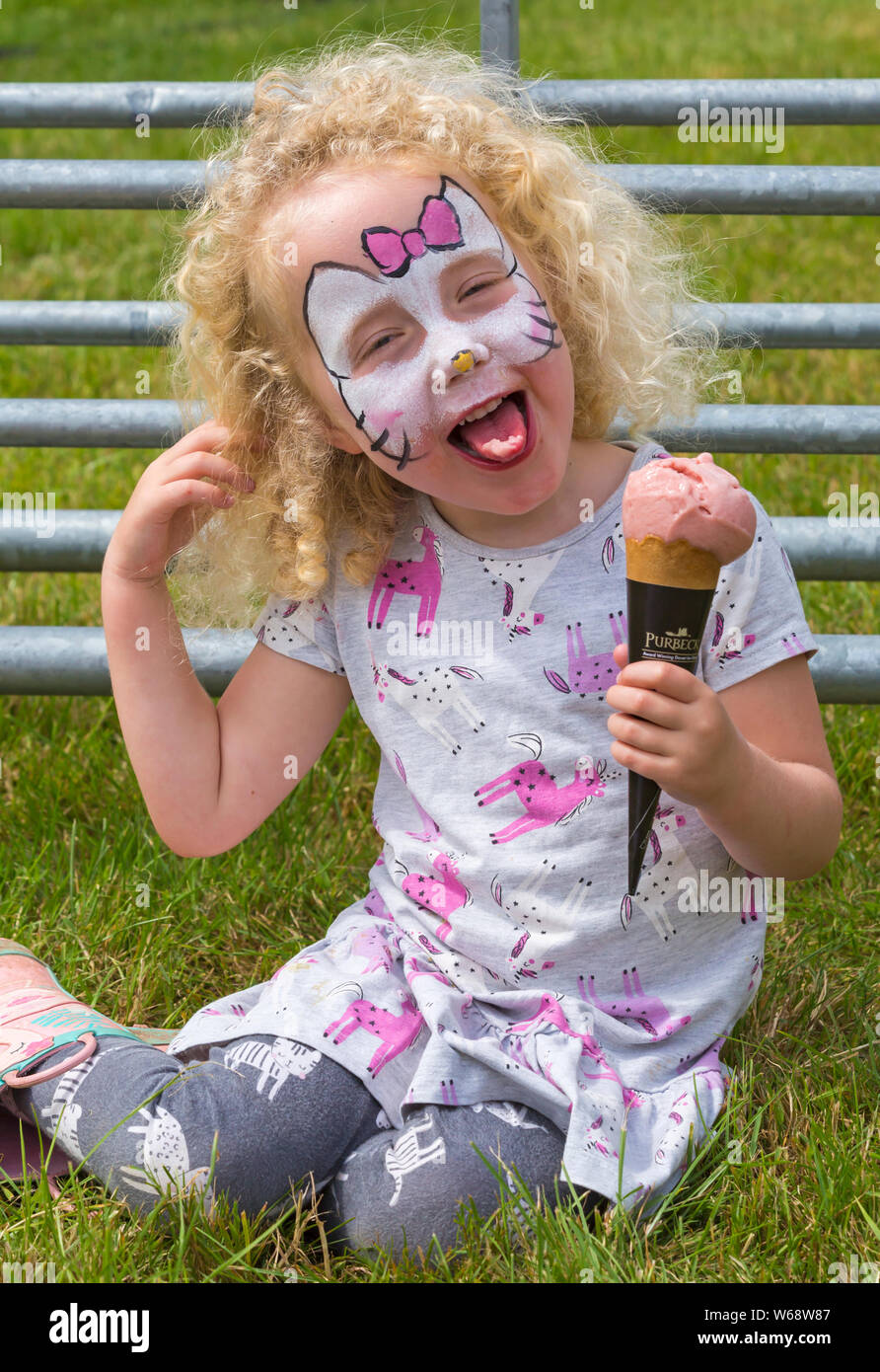 New Milton, Hampshire, Royaume-Uni. Le 31 juillet 2019. Des milliers troupeau au deuxième jour de la Nouvelle Forêt & Hampshire County Show. Quatre ans des jumeaux Rose et Robyn faites une pause pour savourer une glace. Credit : Carolyn Jenkins/Alamy Live News Banque D'Images