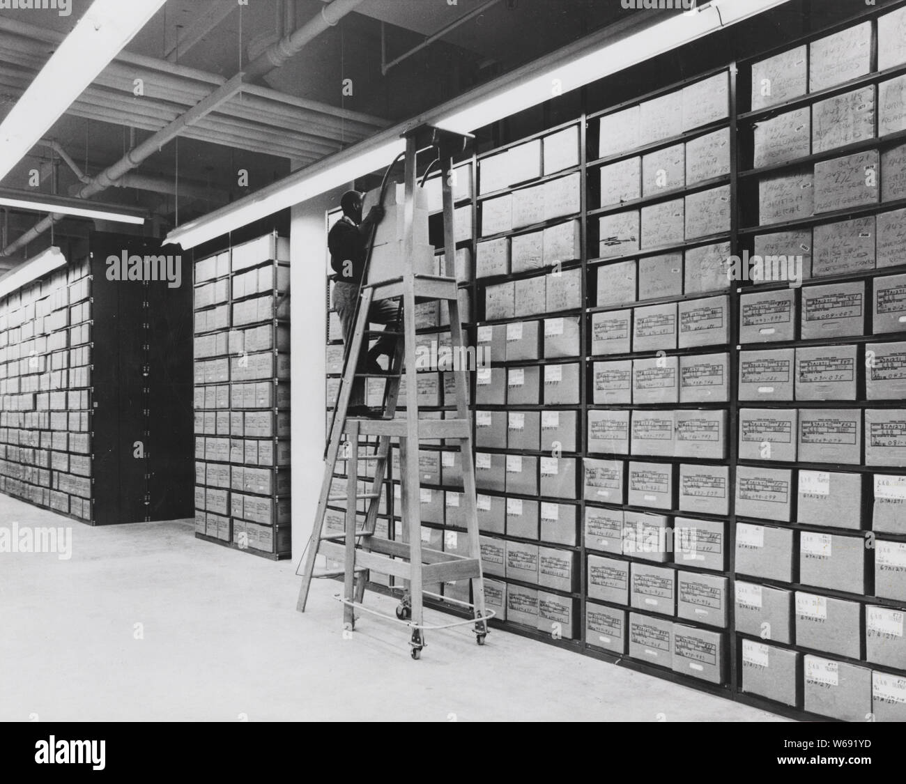 Centre National d'archives de Washington avec une pile de dossiers d'entretien de l'employé ; Portée et contenu : sous-titre original : Washington, Centre National d'archives, avec une pile de dossiers d'entretien de l'employé. Banque D'Images