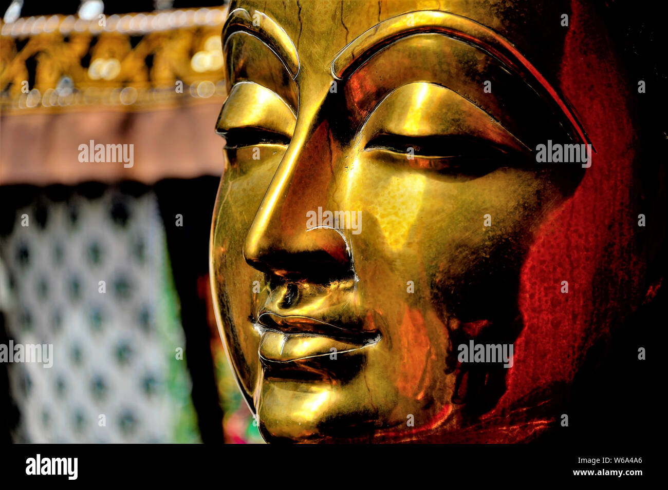 Close up of brass statue de Bouddha montrant le visage avec l'expression calme et de riches tons et textures métalliques Banque D'Images