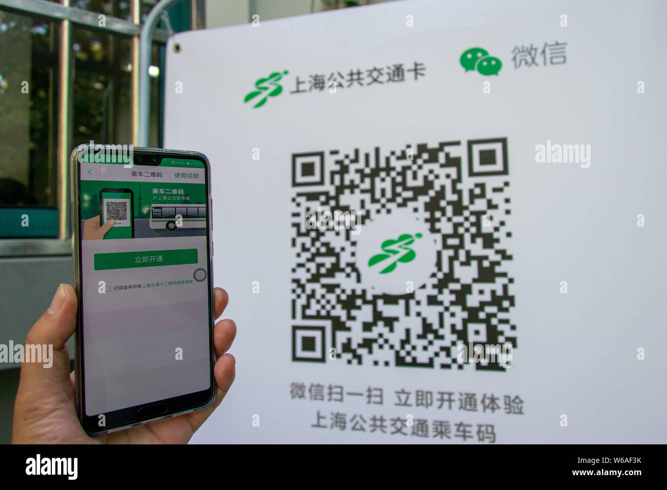 Un utilisateur de téléphone mobile chinois utilise son smartphone pour avoir l'équitation QR code scanné par l'application mobile de Tencent WeChat dans la fonction Paiement Shan Banque D'Images