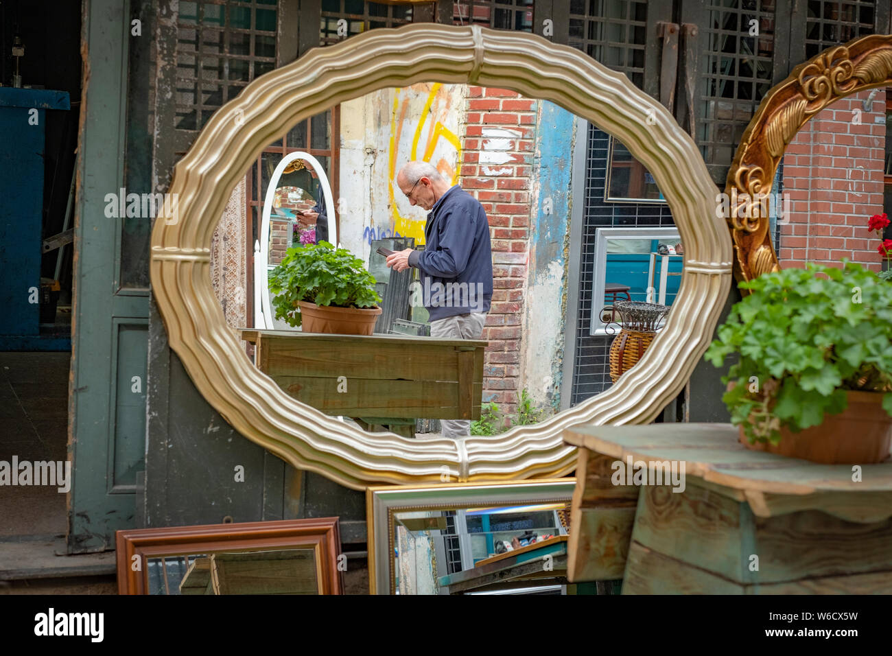 Vue d'un homme turc plus âgés dans un miroir trouvé dans un marché aux puces dans un quartier d'Istanbul, Turquie Banque D'Images