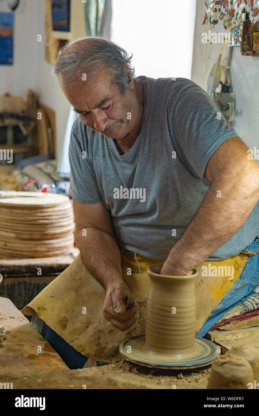 Portrait d'un vieux potter au travail à sa roue faisant de la poterie en céramique dans le style traditionnel de l'île de Lesbos, Grèce Banque D'Images