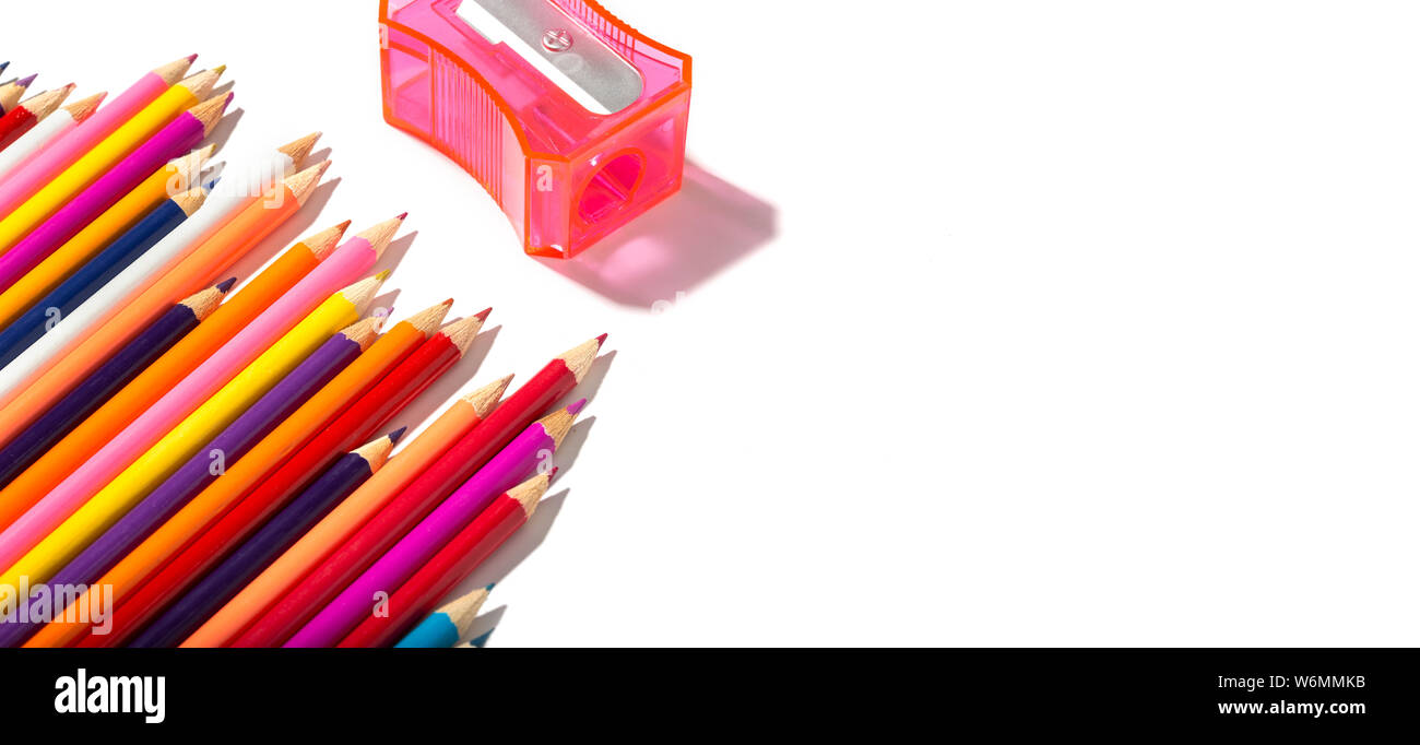Retour à l'école des crayons multicolores de bannière et taille-crayon isolé sur fond blanc. L'espace de copie pour le texte Banque D'Images