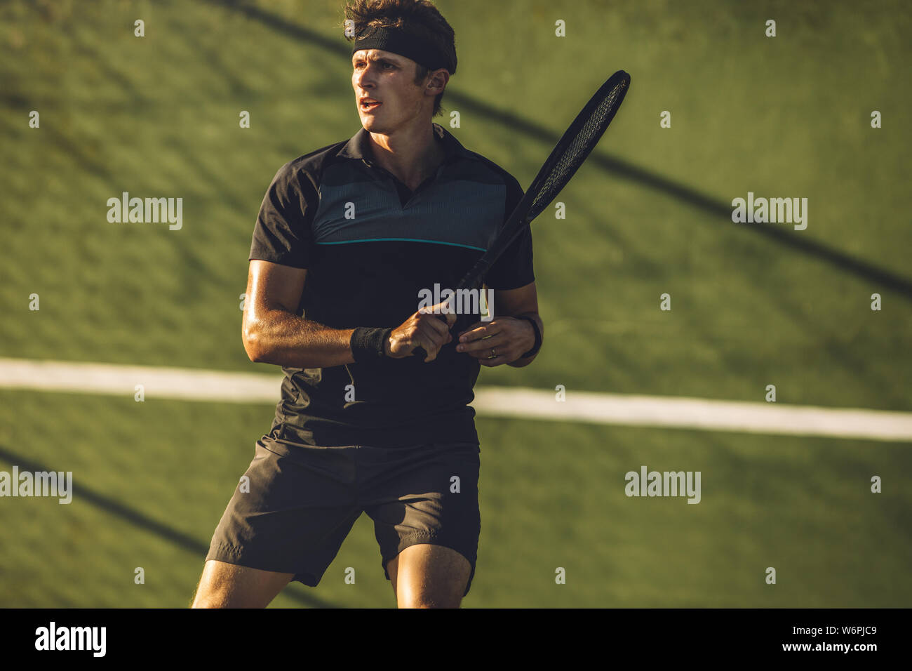 Joueur de tennis pro tennis club pratiquant sur une cour. Jeune joueur de tennis masculin jouant sur une surface dure. Banque D'Images