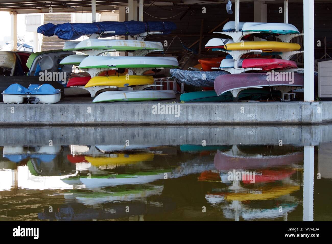Réflexions colorées dans le lac de la canots et kayaks dans l'entreposage à pavillon du lac Dow, Ottawa, Ontario, Canada. Banque D'Images