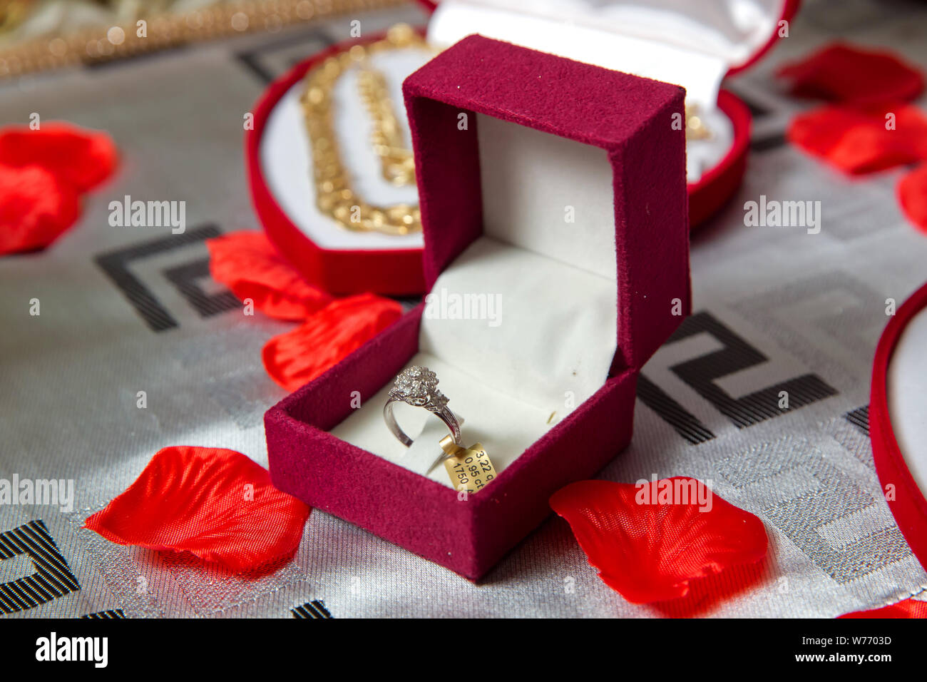 La bague rouge .boîte de bague de fiançailles en or dans une boîte en forme de coeur et des roses Banque D'Images