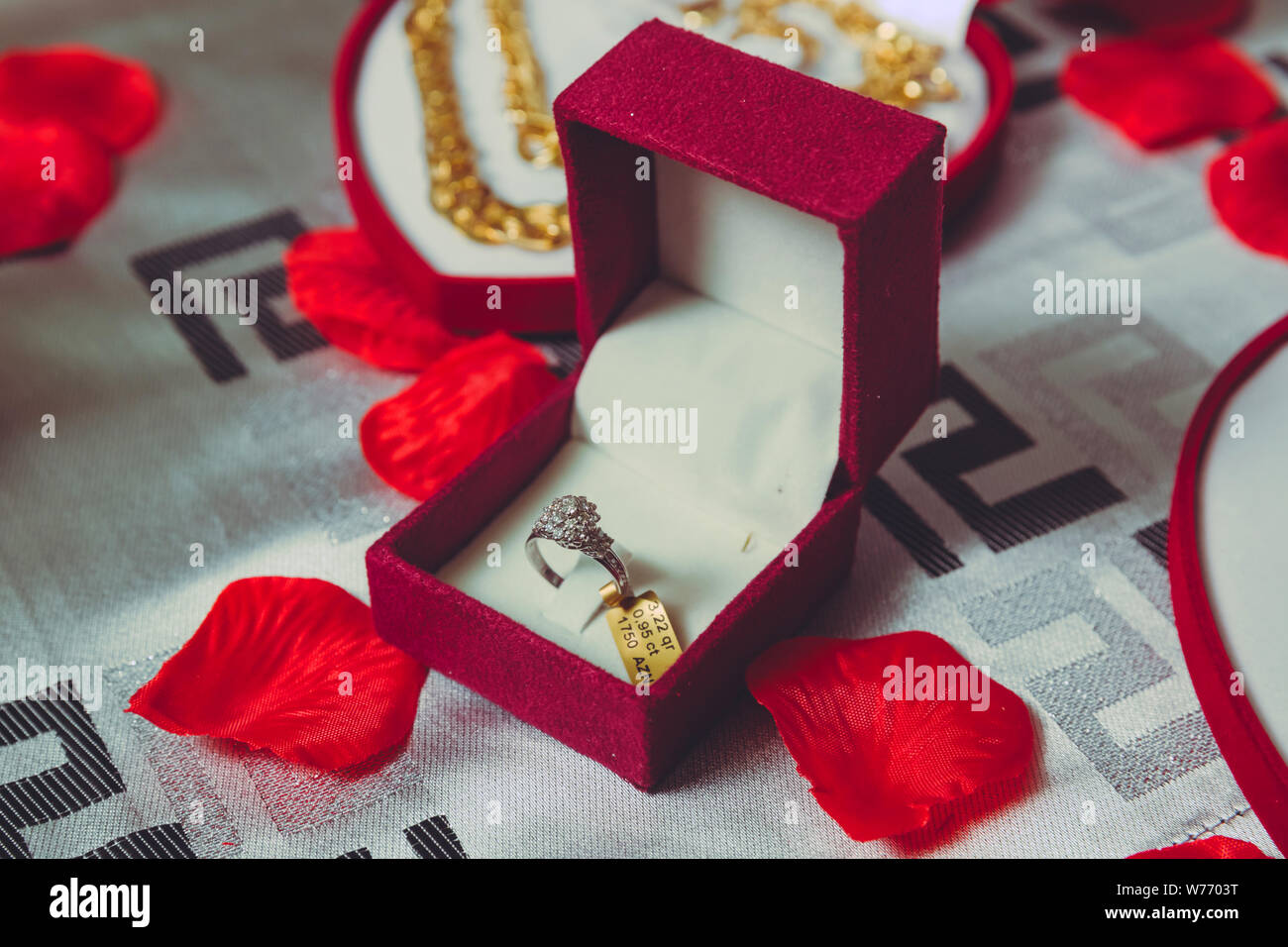 La bague rouge .boîte de bague de fiançailles en or dans une boîte en forme de coeur et des roses Banque D'Images