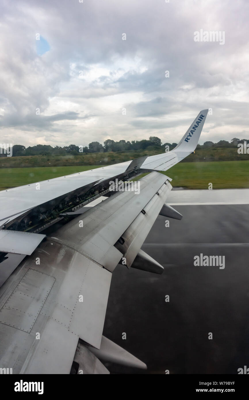 Ouverture des volets de l'aile sur un Boeing 737 800 Ryanair - atterrissage sous la pluie sur la piste de l'aéroport de Manchester Banque D'Images