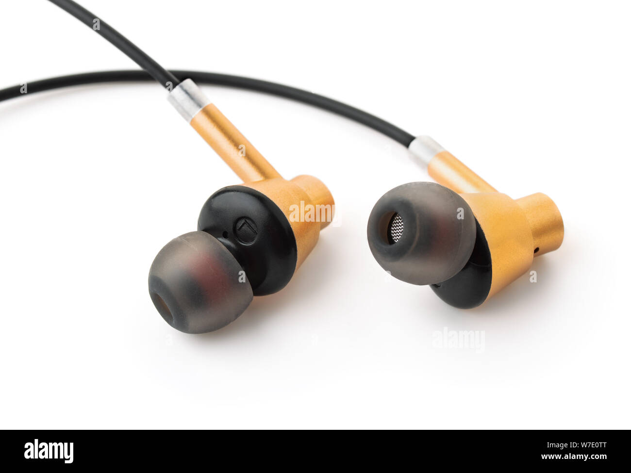 Close up of golden ear buds isolated on white Banque D'Images