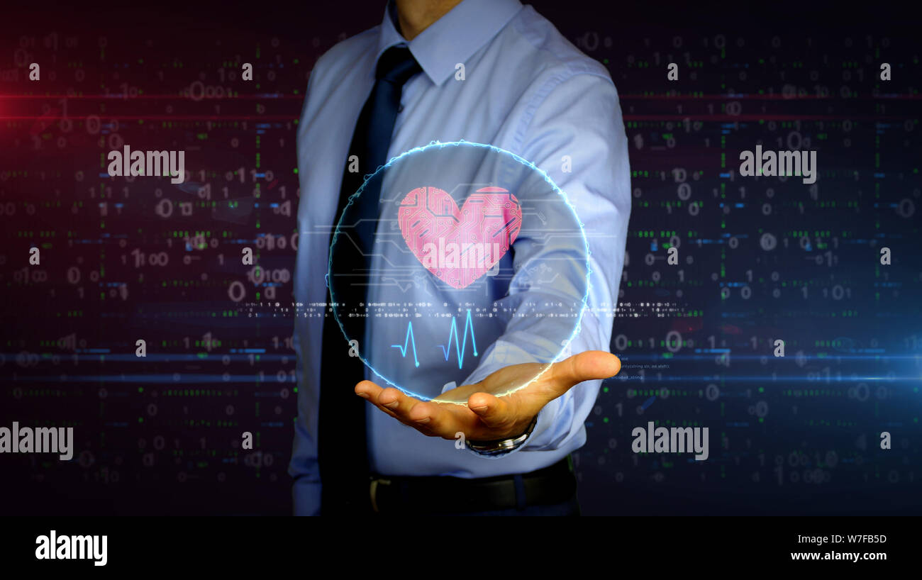 L'homme avec le symbole du cœur cybernétique dynamique hologramme sur la main. Homme d'affaires et de l'amour, concept futuriste cyber dating, romantique, de la santé, de la science et de location Banque D'Images