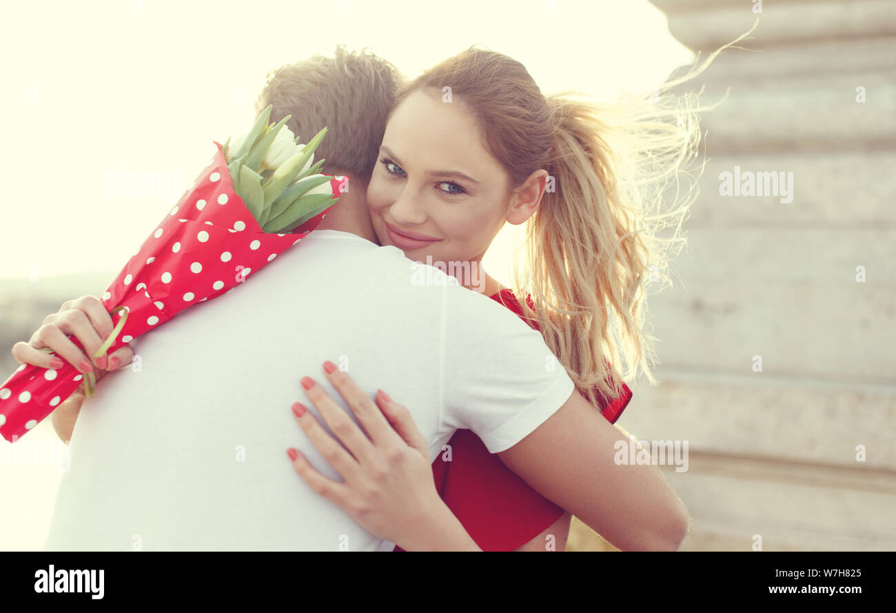 Young blonde woman embracing man sur la date à l'extérieur Banque D'Images