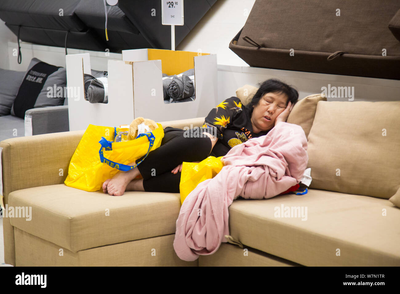 Un client chinois prend une sieste sur un canapé affichée à l'ameublement  de magasin IKEA dans la ville de Hangzhou, Zhejiang Province de Chine  orientale, le 4 juillet 2017. Un Photo Stock -