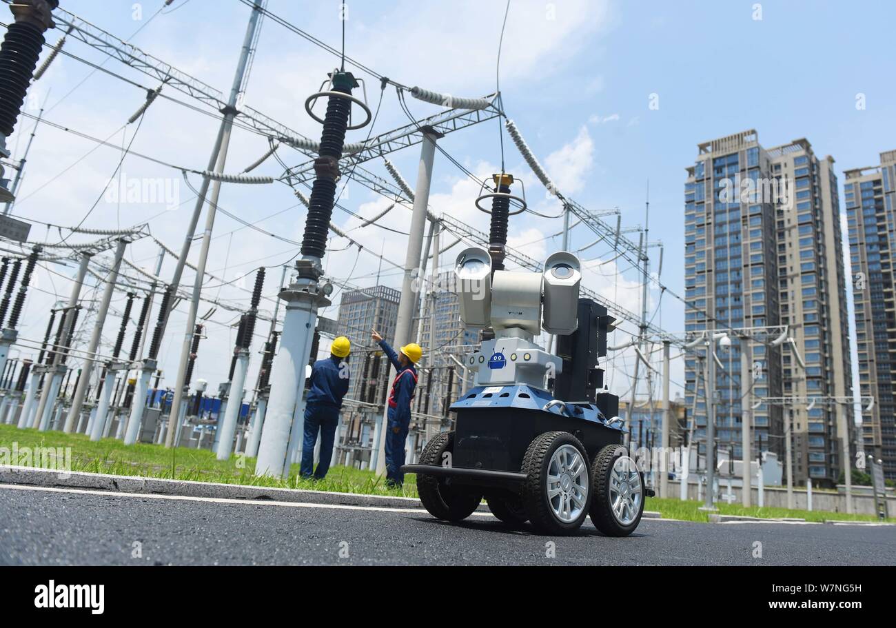 Un robot est représenté comme il est utilisé pour aider les travailleurs chinois vérifier la sous-station au cours des jours torrides à un poste de transformation électrique à Chuzhou Banque D'Images