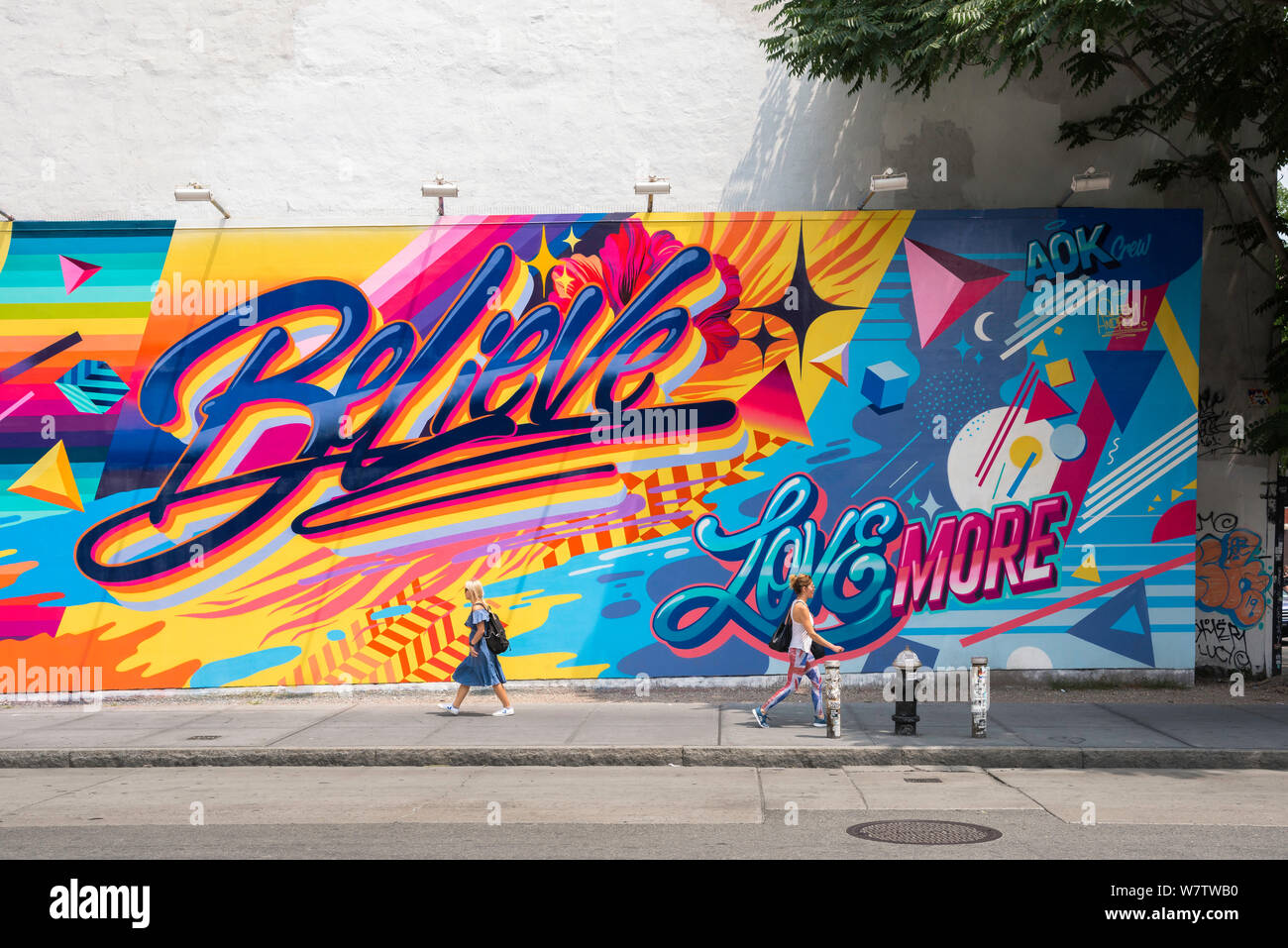 Croyez message positif, vue en été de l'art de rue coloré dans l'East Village exhortant les passants à croire, Manhattan, New York City, Etats-Unis. Banque D'Images