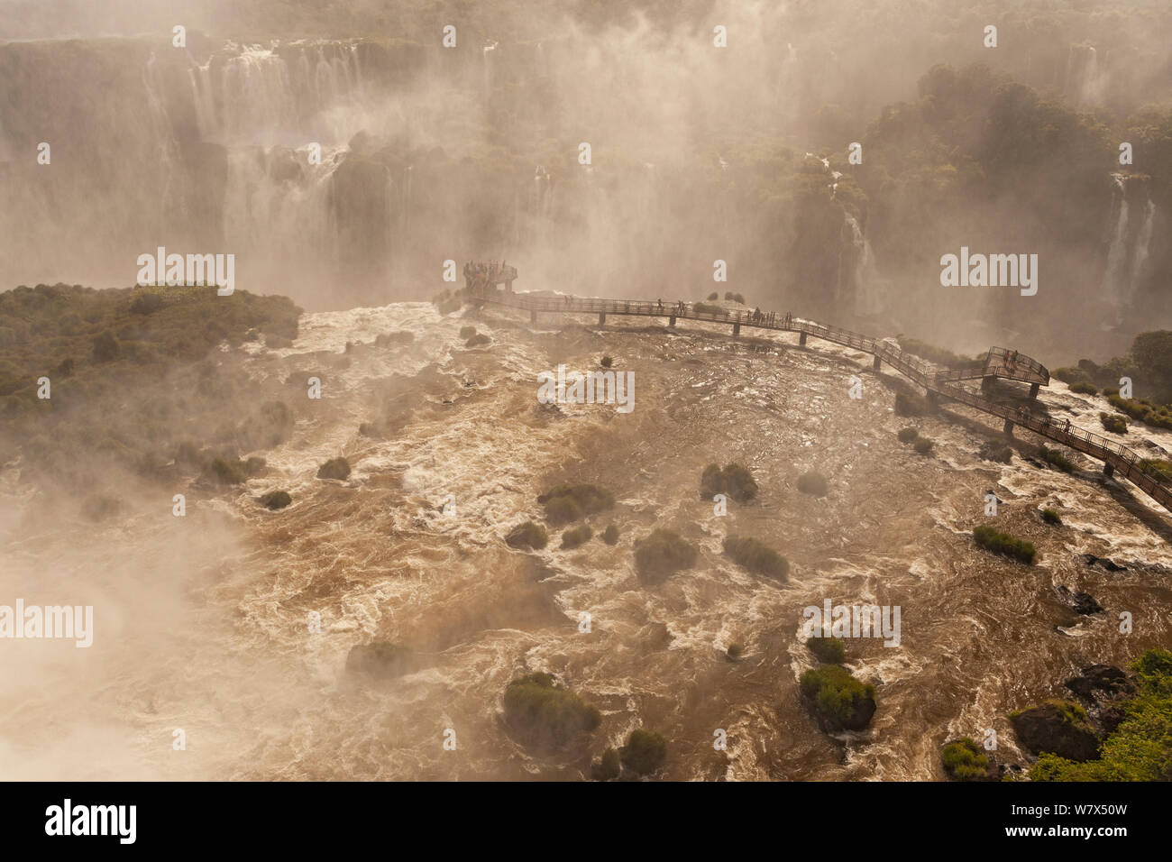 Paysage de l'Iguazu Falls dans le brouillard, avec les touristes sur l'affichage de la plate-forme, d'Iguazu, le Parc National d'Iguaçu, Brésil, janvier 2014. Banque D'Images
