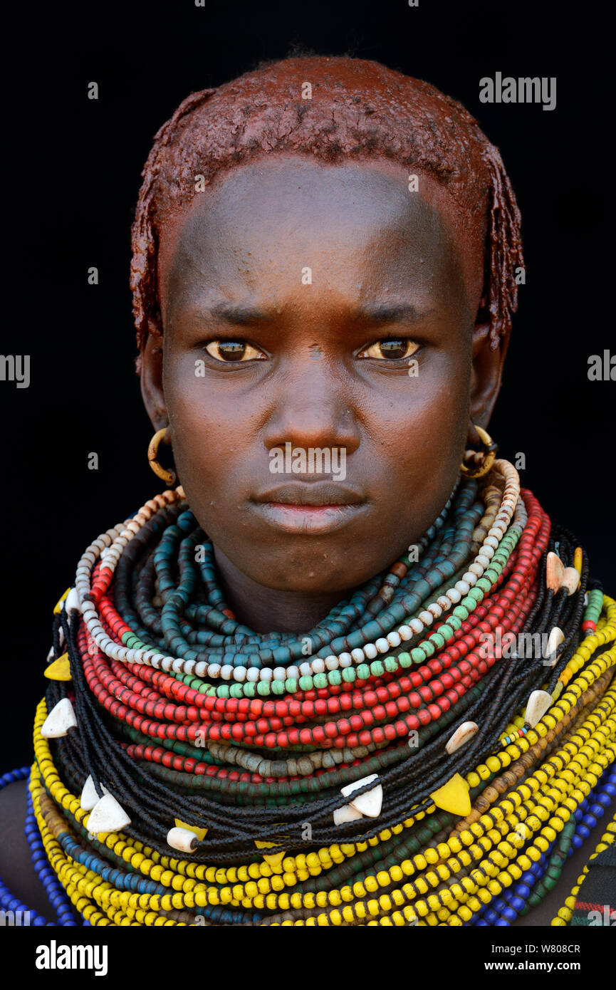 Jeune femme de la tribu Nyangatom, avec colliers traditionnels et les cheveux couverts d'ocre et de graisses animales, vallée de l'Omo, en Ethiopie, en mars 2015. Banque D'Images