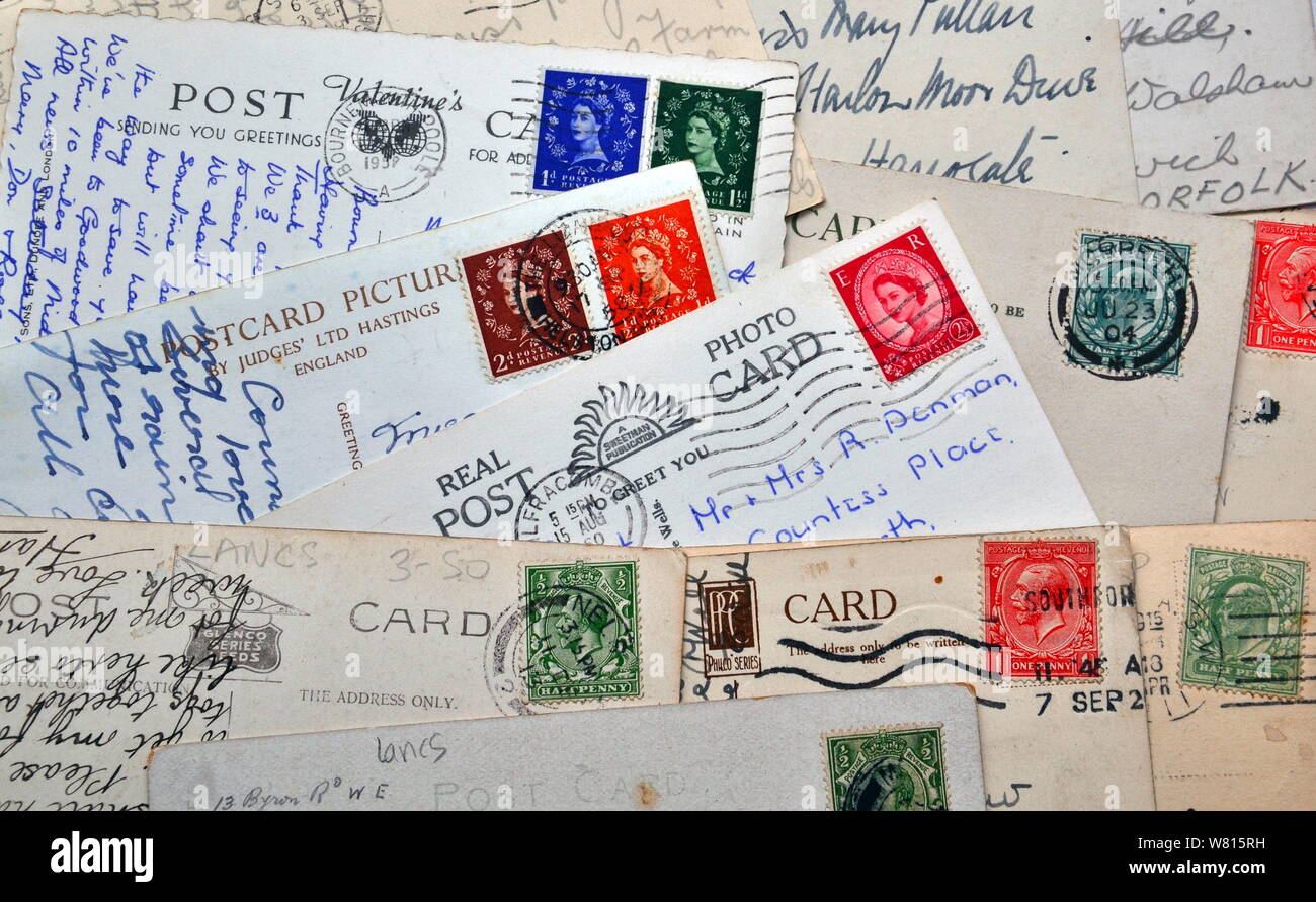 De marche arrière vintage xxe siècle cartes postales avec l'anglais écrit et ancien affranchi timbres-poste sur eux Banque D'Images